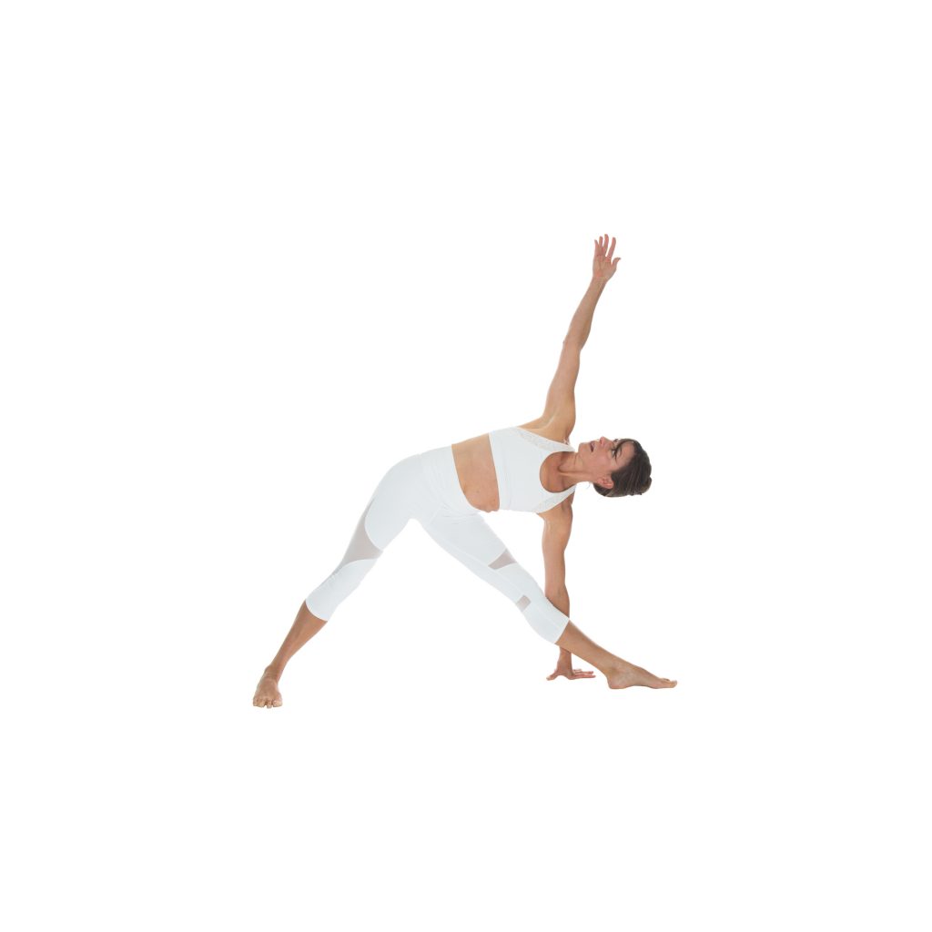 woman practices triangle pose basic yoga