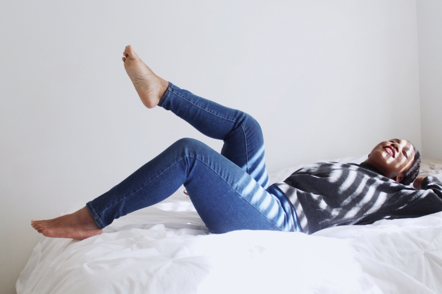 woman relaxes on a bed