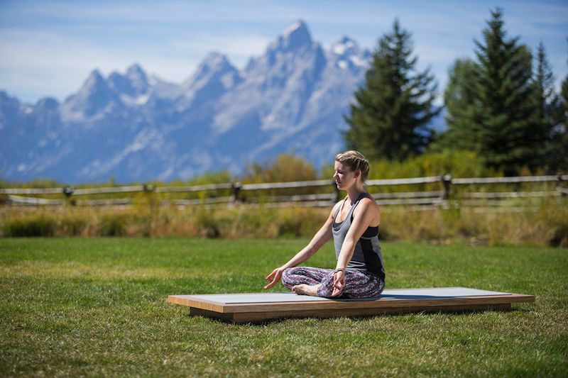 woman meditates in Jackson Hole, Wyoming -yogatoday