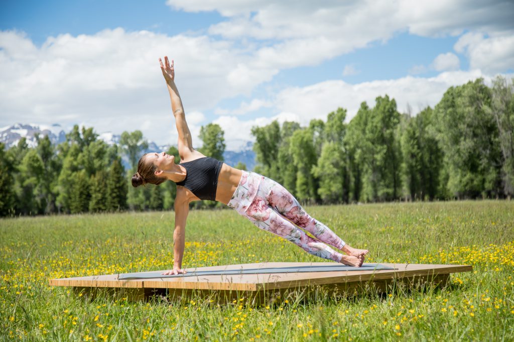 Pilates instructor practices side plank pose for core strength and healthy weight loss -yogatoday