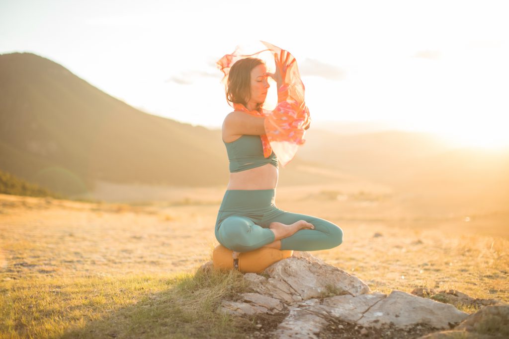 woman practices meditation and self-care to relieve headaches - yogatoday