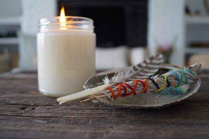 zen yoga space with candle, feather and sage -yogatoday