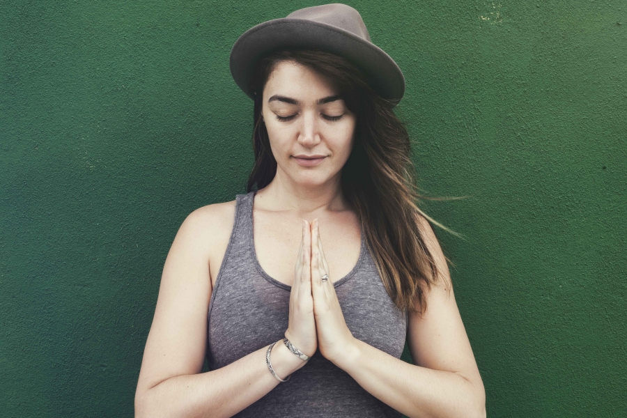 woman with her hands in prayer pose -yogatoday