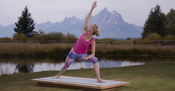 woman practices side angle pose- yogatoday