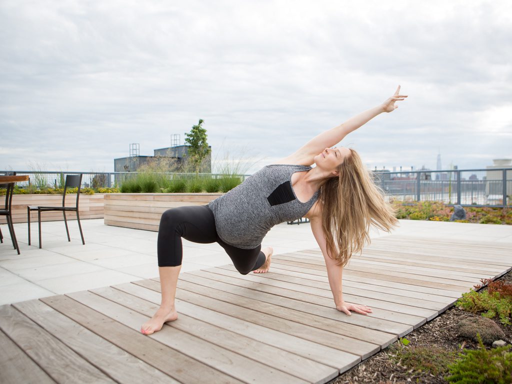 pregnant woman practices a prenatal yoga pose low lunge variation