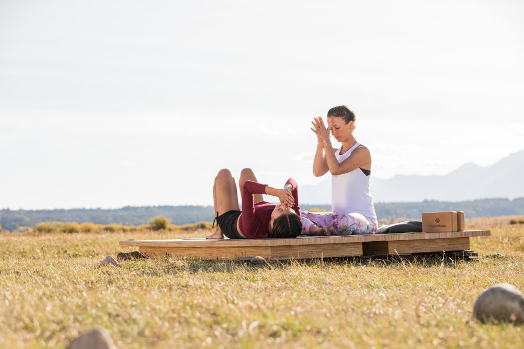 yoga teacher and student practice constructive rest - yogatoday