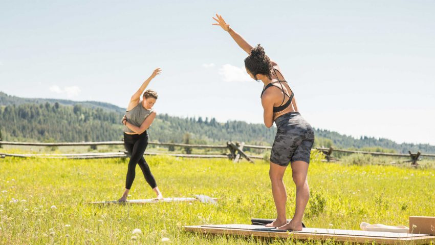 two women practice yoga in Grand Teton National Park