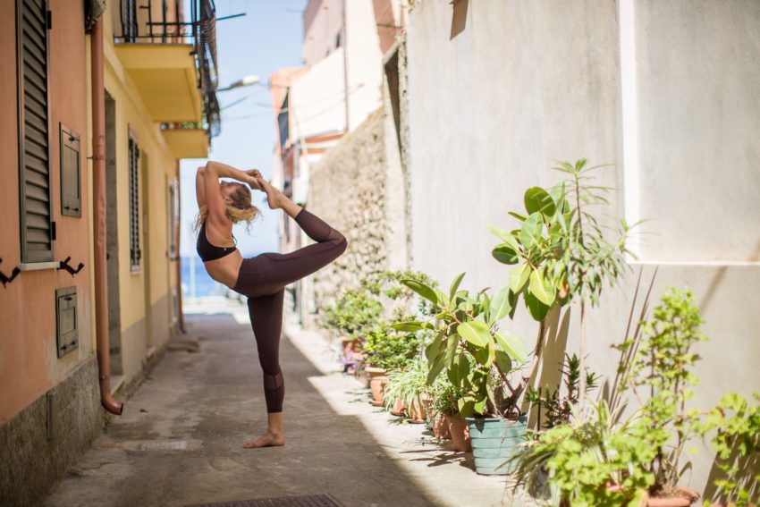 woman practices yoga in Italy in the springtime